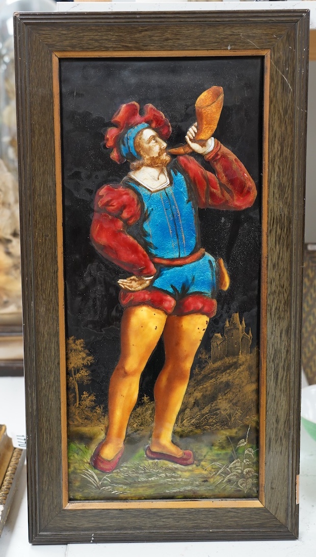 A framed Limoges enamel panel of a medieval man blowing a horn, overall 47 x 25cm. Condition - good